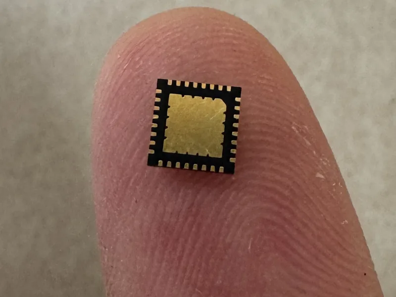 The custom ADC chip on a fingertip